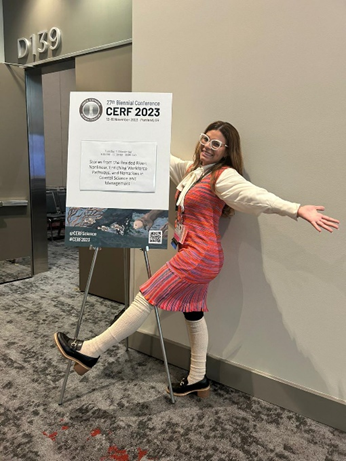 Stephanie Lopez poses next to a CERF 2023 conference sign