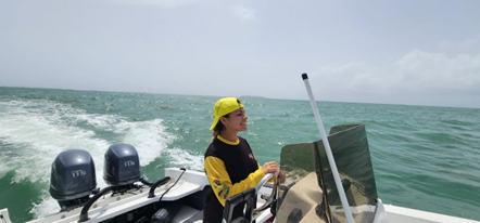 Stephanie Lopez drives a boat on open water